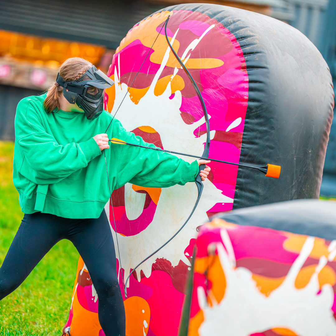 Kid playing Archery Tag behind inflatable cover during a Battle Zone birthday party at Gripped London.