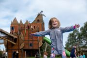 Young child playing in front of the Hobbledown Epsom adventure castle