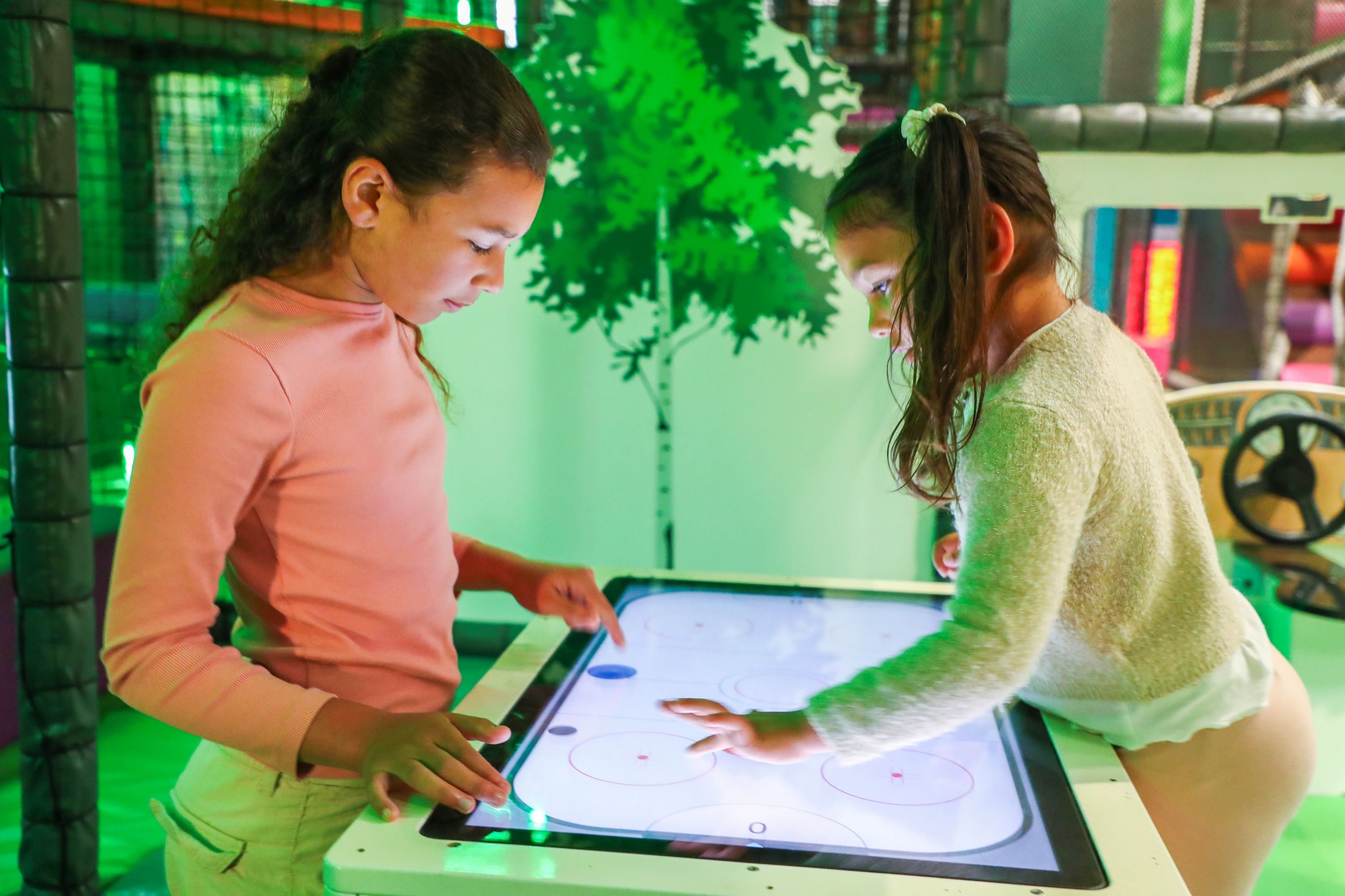 Children playing interactive game at indoor play area in Hounslow
