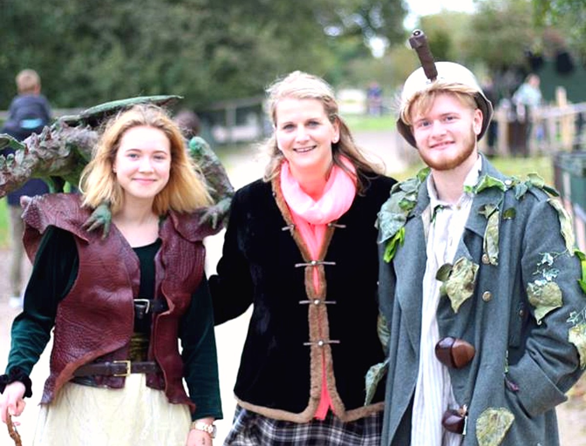 Hobbledown characters in costume meeting a family and posing together during a live experience