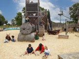 Children playing in the sandpit at the Mining Village themed outdoor adventure area at Hobbledown Heath, Hounslow