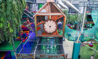 Multi-level indoor climbing frame with clock tower feature at Hobbledown Heath indoor play centre, Hounslow, West London