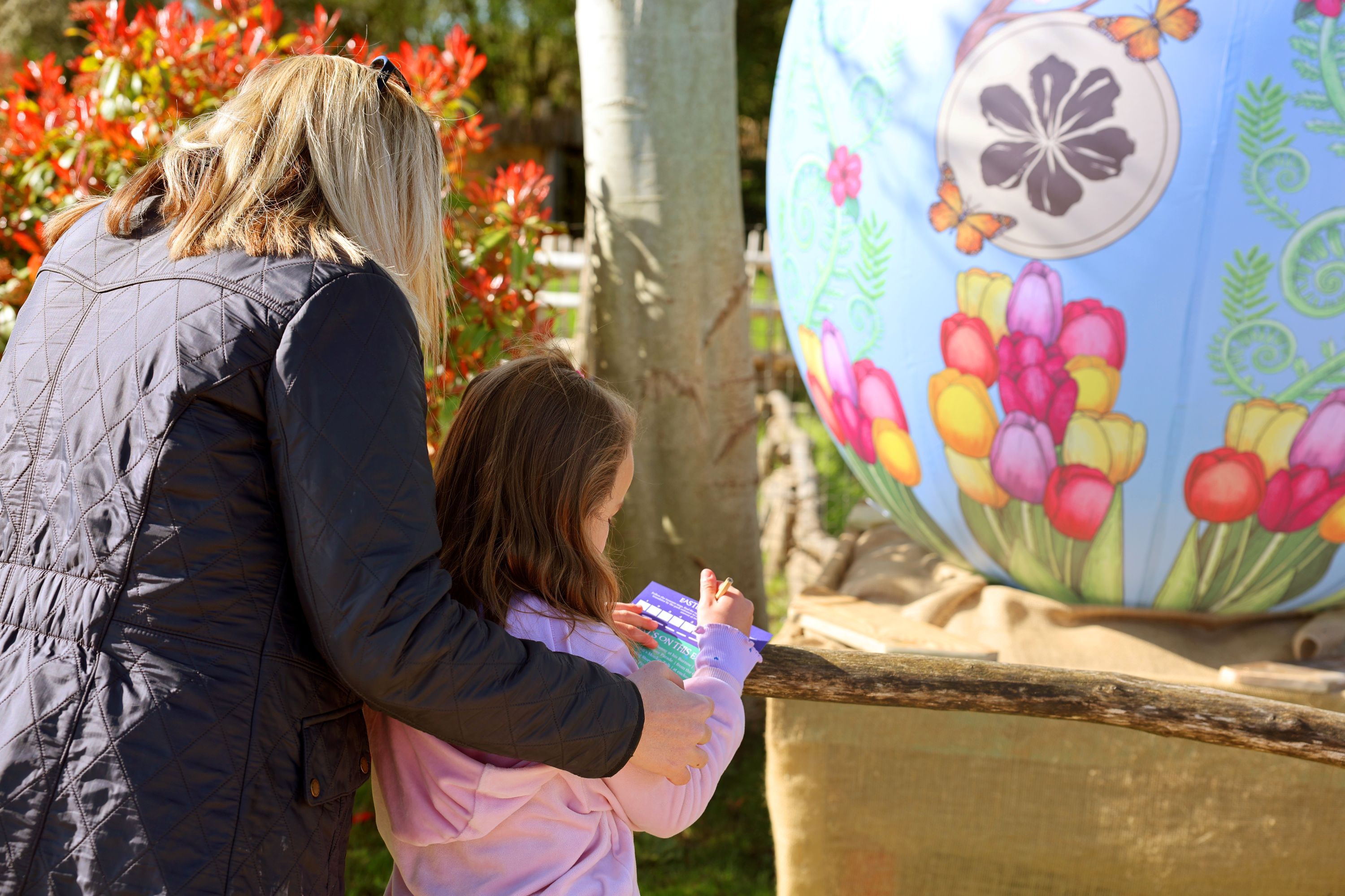 Family enjoying an Easter egg hunt activity at Hobbledown Epsom Surrey