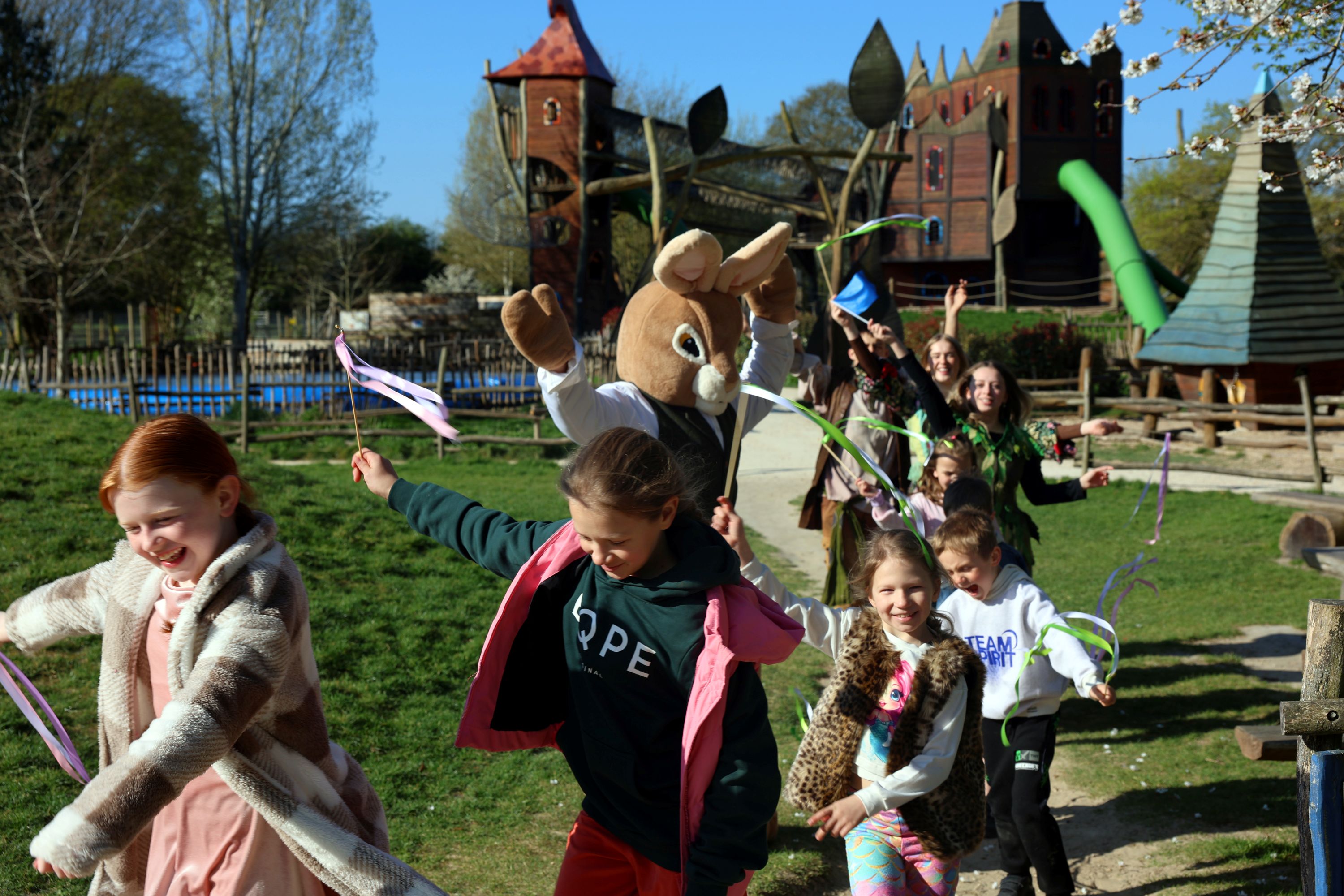 Kids enjoying an Easter event parade at Hobbledown Epsom Surrey with Easter Bunny character