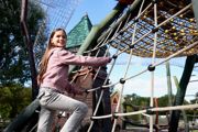 Child climbing a rope structure at Hobbledown Epsom playground