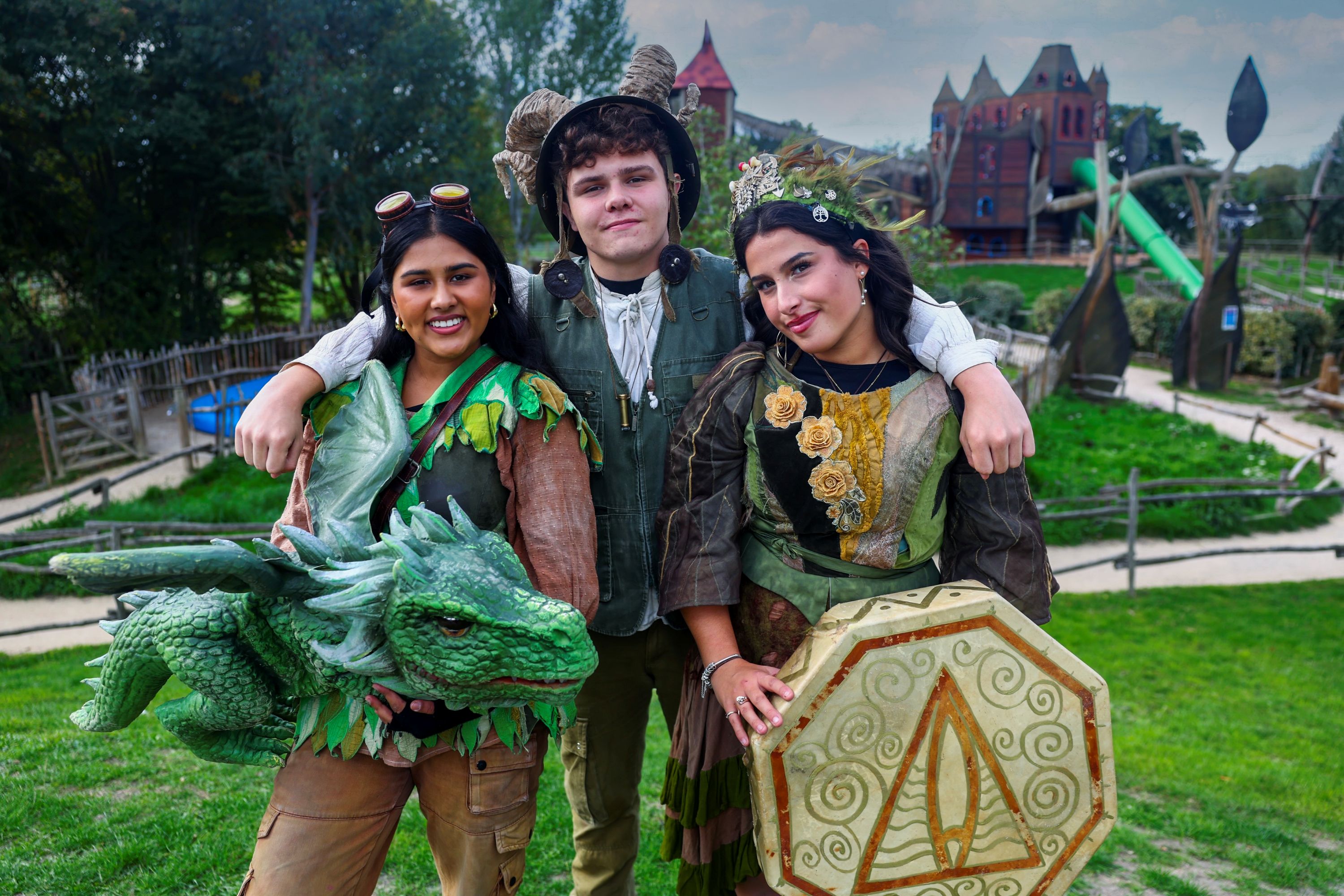 Hobbledown characters posing with a dragon in the adventure park