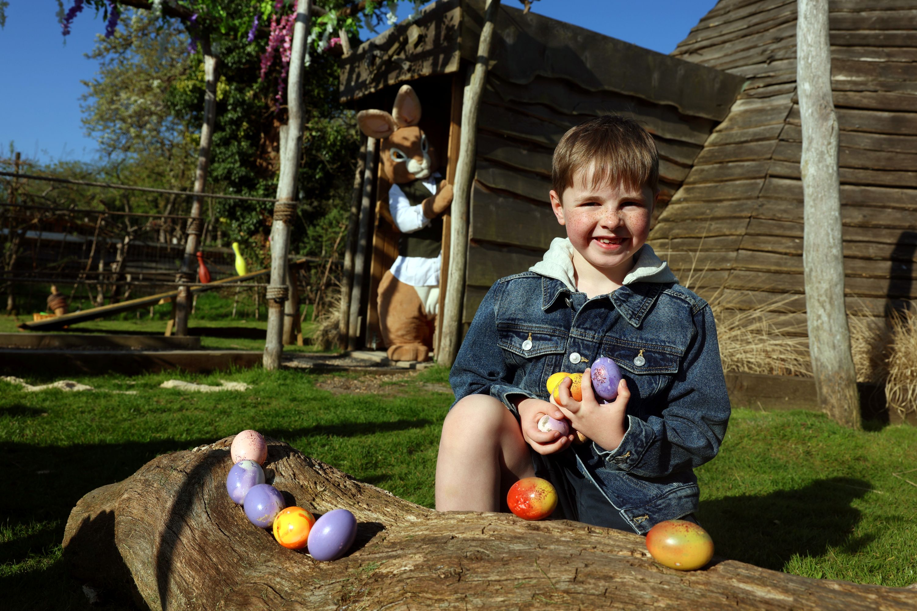 Child enjoying an Easter egg hunt at Hobbledown Epsom Surrey with Easter Bunny character