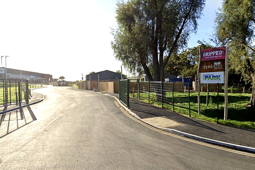 Entrance road and signage for Gripped and Hobbledown Heath at Hounslow Heath