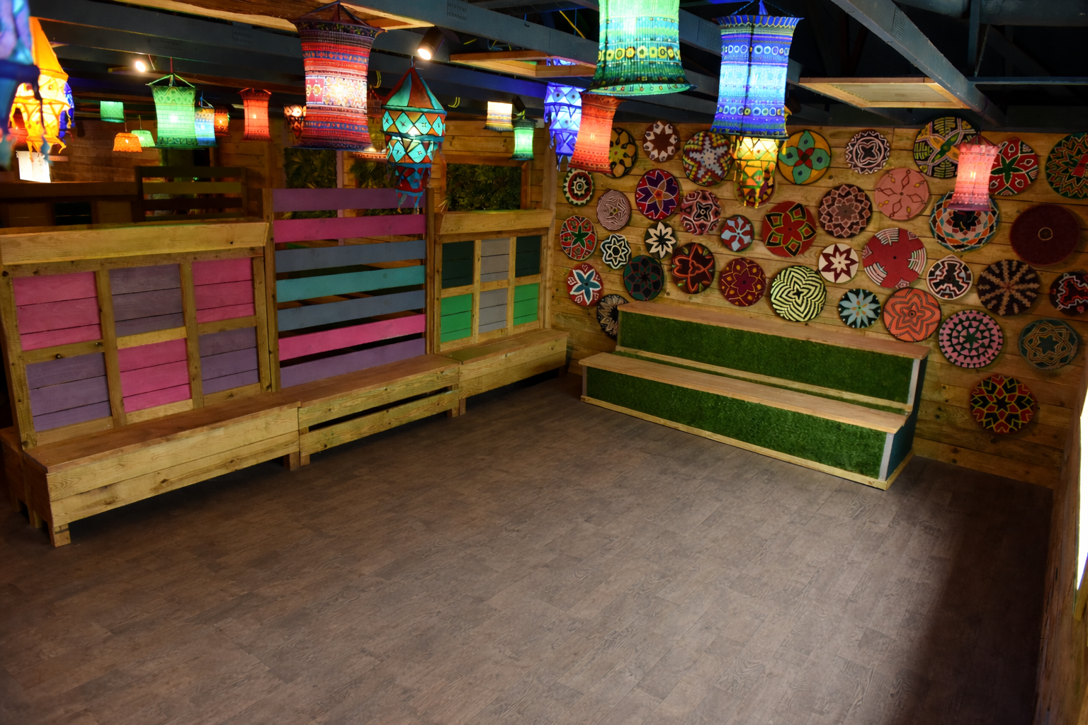 Indoor community meeting space at Hobbledown Epsom with colourful lantern lighting and open floor area.