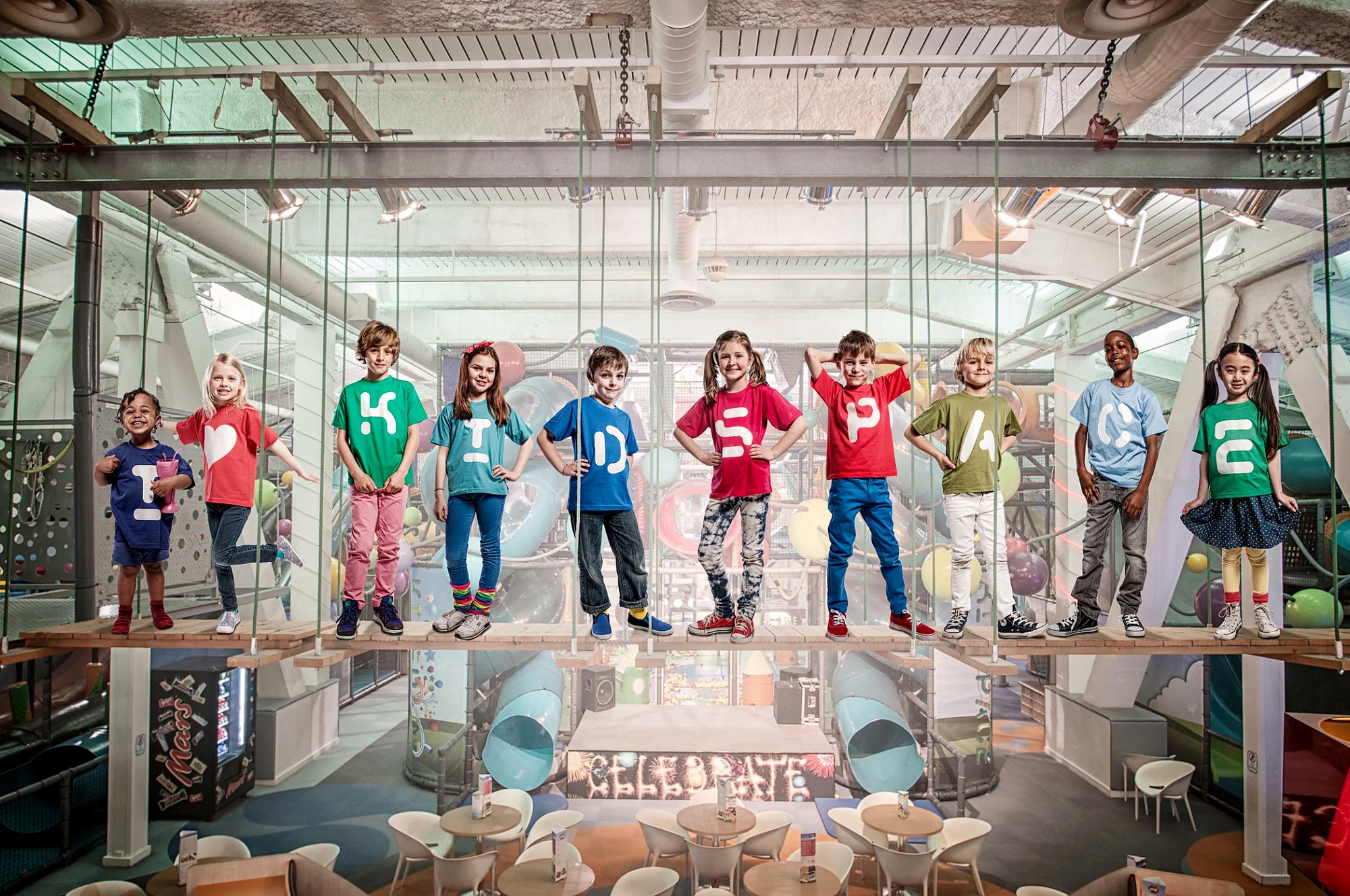 Children standing on a suspended bridge inside Kidspace indoor play centre